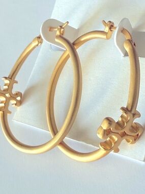 Tory Burch Kira Gold Hoop Earrings with Logo Charm.